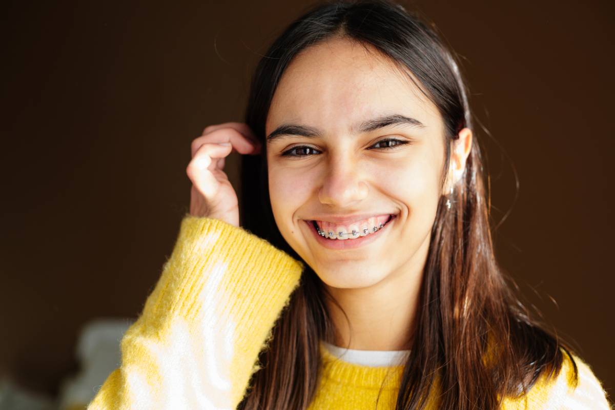 Woman wearing braces and smiling