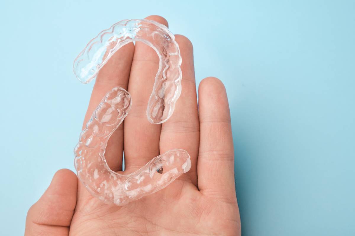 concept image of invisalign on palm to choose